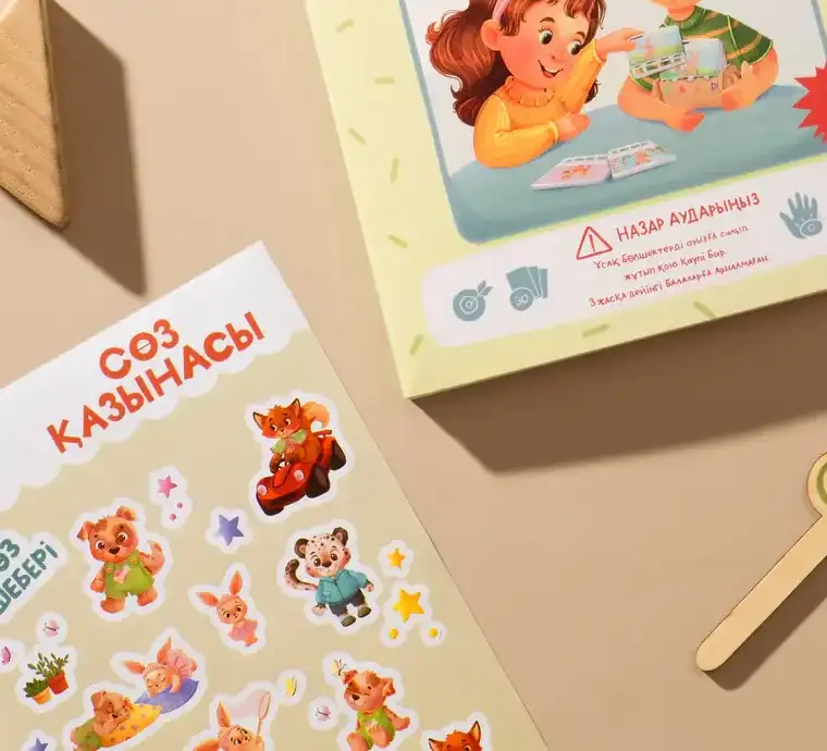 Лист наклеек с героями игры рядом с коробкой